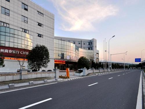 an empty street in front of a building at Fliport Garden Hotel Nanjing in Nanjing