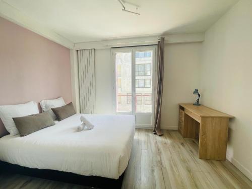 une chambre avec un grand lit blanc et une fenêtre dans l'établissement La perle du lac, à Thonon-les-Bains