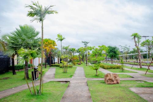 a park with palm trees and a rock at Wonderland Suites and Resort in Sihanoukville