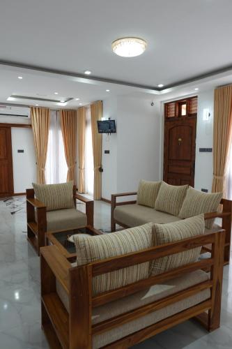 a living room with two couches and a table at AirBlue Villa in Ratmalana
