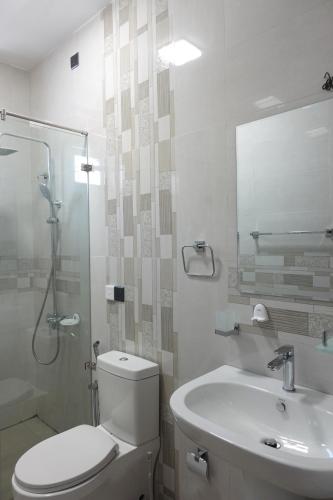 a bathroom with a toilet and a sink and a shower at AirBlue Villa in Ratmalana