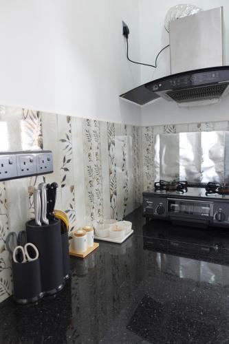 a kitchen with a stove and a counter top at AirBlue Villa in Ratmalana