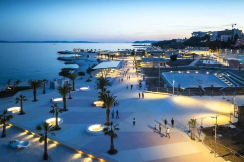 an aerial view of a city at night at Apartment ŽNJAN in Split