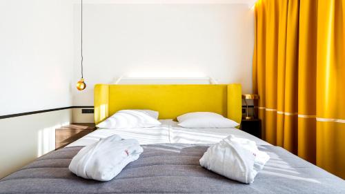 a bed with two white pillows on top of it at Qubus Hotel Kraków in Kraków