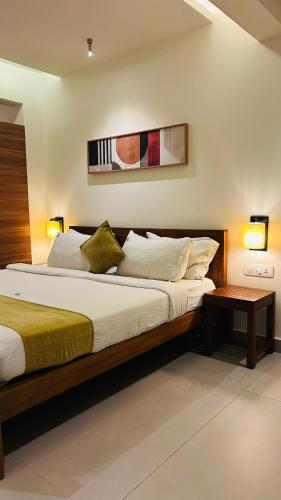 a bedroom with a large bed with two lamps at SylVan Resort in Wayanad