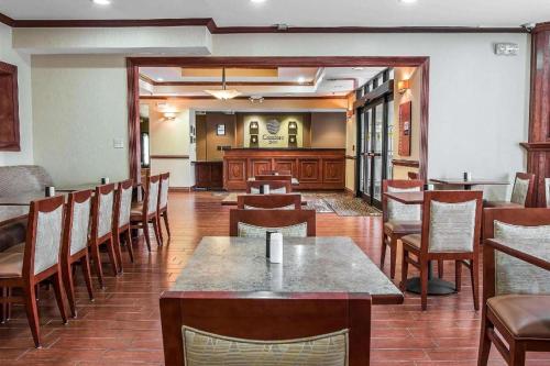 a restaurant with wooden tables and chairs and a room with tables at Comfort Inn & Suites University South in Ann Arbor