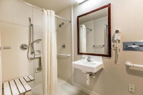 a bathroom with a sink and a shower with a mirror at Quality Inn Homewood Birmingham I-65 in Birmingham