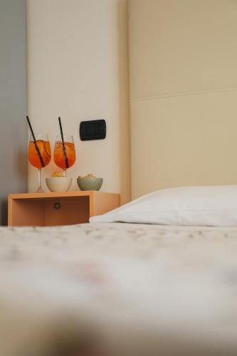 a bedroom with a bed and two vases on a table at Hotel Eden in Bardolino