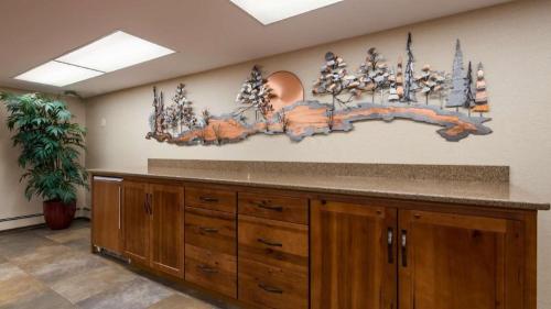 a large kitchen with a counter and a painting on the wall at Quality Inn & Suites Detroit Lakes in Detroit Lakes
