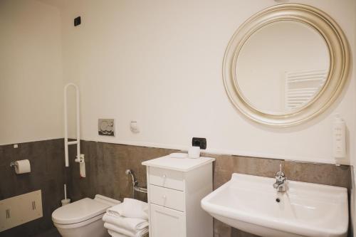 a bathroom with a sink and a toilet and a mirror at Hotel Eden in Bardolino