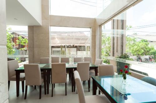 a dining room with a table and chairs at Blue Sky Phu Quoc Hotel in Phu Quoc