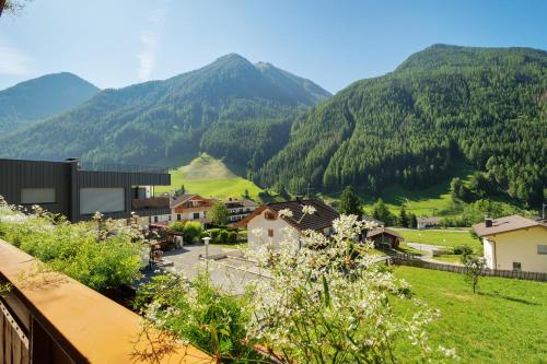 a view of a village with mountains in the background at Pension Waldheim Apartments in San Giacomo