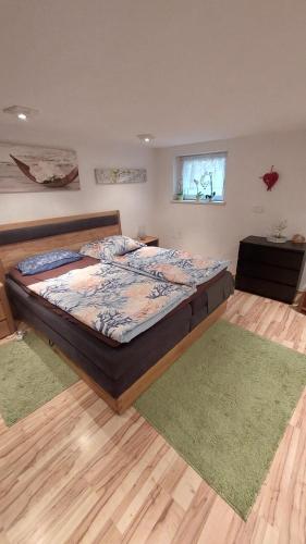 a bedroom with a large bed in a room at Zoe's Ferienwohnung in Kleinvolderberg