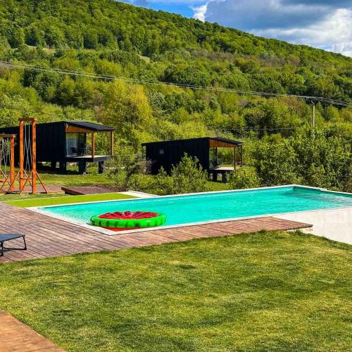 a swimming pool in the grass next to a house at LakeView Villas 