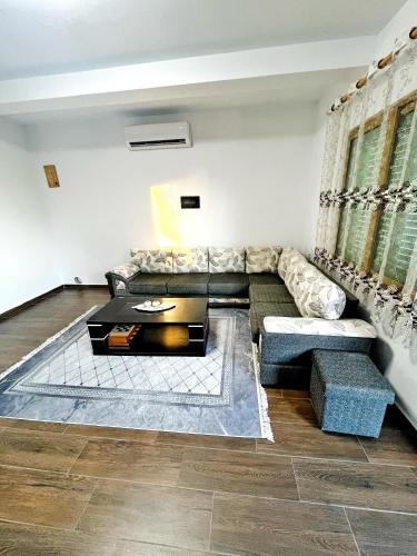 a living room with a couch and a table at OLIVE Home in Durrës