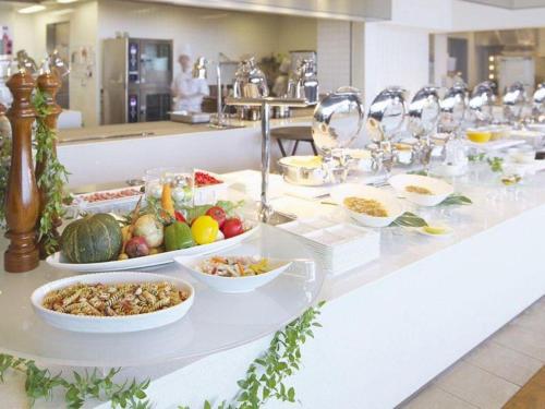 a buffet with plates of food on a counter at Nippondaira Hotel in Shizuoka