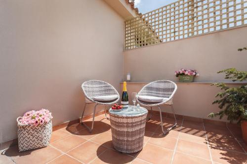 a patio with two chairs and a table at Matarolux 5 in Mataró