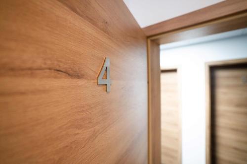a wooden door with the number four on it at Motel Q in Jestetten