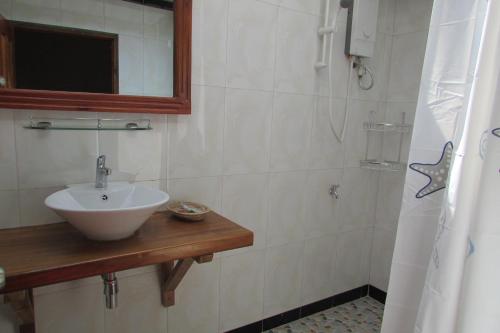 y baño con lavabo y ducha. en Phoumrumduol Bungalow en Kampot