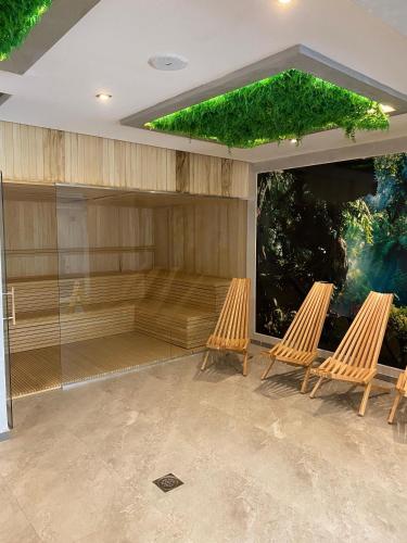 two chairs sitting in front of a large screen at Apartman Tornik Relax&Spa 2 in Zlatibor