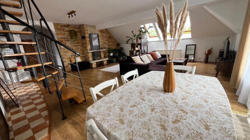 a living room with a table with a vase on it at Apartament Zamoście in Zamość