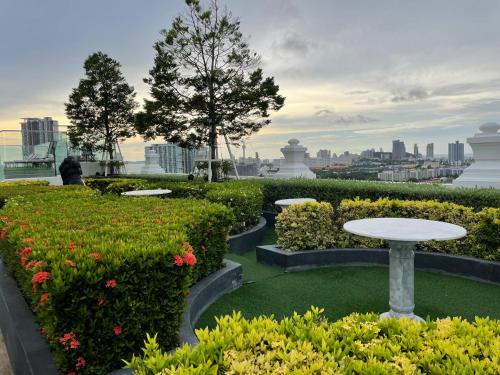 un jardin avec une table et des fleurs sur un toit dans l'établissement The Empire Tower Pattaya, à Jomtien Beach