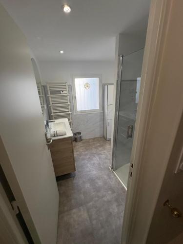 a bathroom with a shower and a sink and a mirror at La Petite Étoile d'Avignon in Avignon