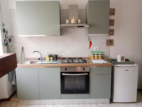 a kitchen with a sink and a stove top oven at Verde Chiara in Chieti