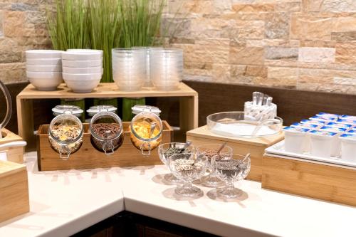 a table with wine glasses and other items on it at Hotel Mary Rose in Lazise