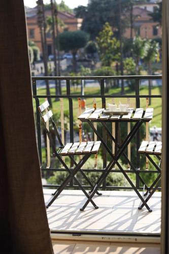a table and chairs sitting on a balcony at 49 Downtown Pompeii in Pompei