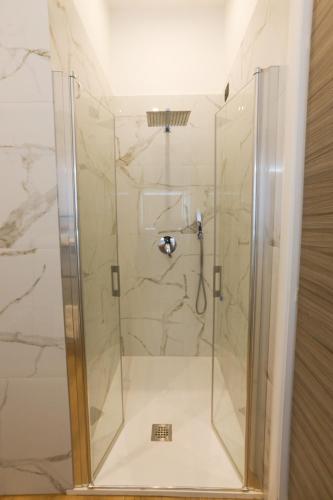 a shower with a glass door in a bathroom at 49 Downtown Pompeii in Pompei