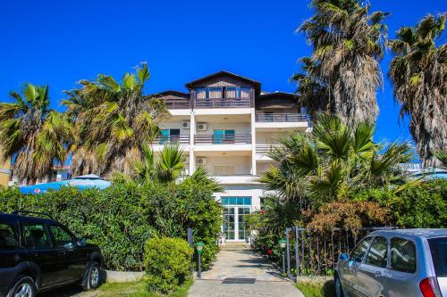 a building with palm trees in front of it at Hotel Venezia in Golem