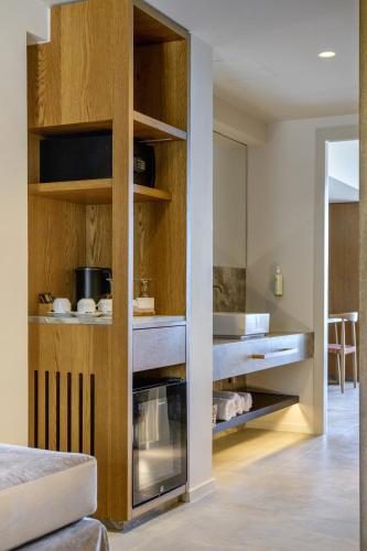 a kitchen with wooden cabinets and a stove in it at Blue Sea Beach Affiliated By Melia in Stalida
