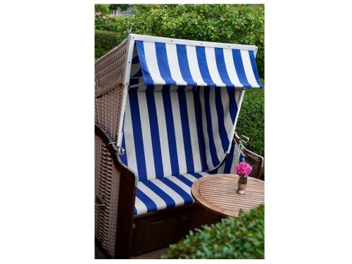 a blue and white beach chair with a table at Haus Leißner in Büsum