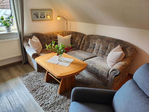a living room with a couch and a table at Haus Leißner in Büsum