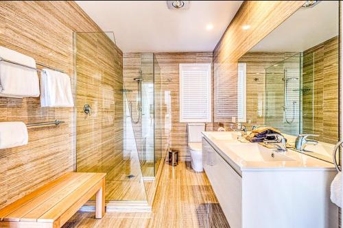 a bathroom with a sink and a shower at Beautiful architecturally & interior designed home in Karikari Peninsula