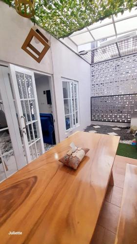 a wooden table with a bow on top of it at Zara Home Lembang in Padasul