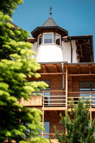 a building with a lighthouse on top of it at Corona Dolomites Hotel in Andalo