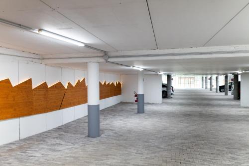 an empty room with white walls and white columns at Corona Dolomites Hotel in Andalo