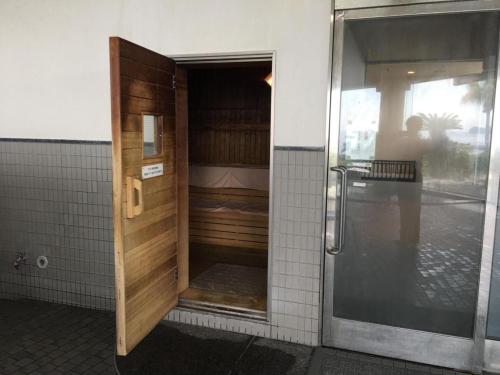 an open door to a bathroom with a shower at Hotel Harvest Nankitanabe in Tanabe