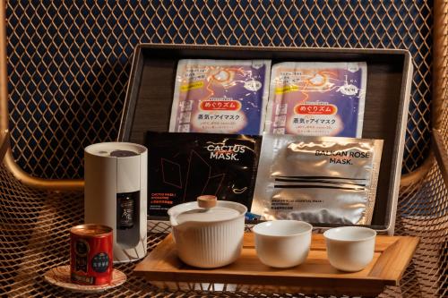 a wooden tray with cups and a box of milk at 墾丁耳東華苑ErDong Manor in Kenting