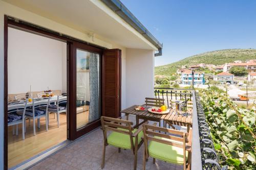 a balcony with a table and chairs and a view at Apartments Beata in Marina