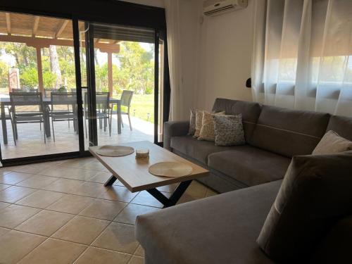 a living room with a couch and a coffee table at Villa-Alpha in Kassandria