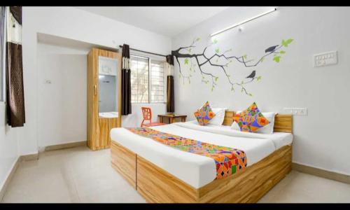 a bedroom with a large bed in a room at Super Hotel O Sai inn 2 in Pune