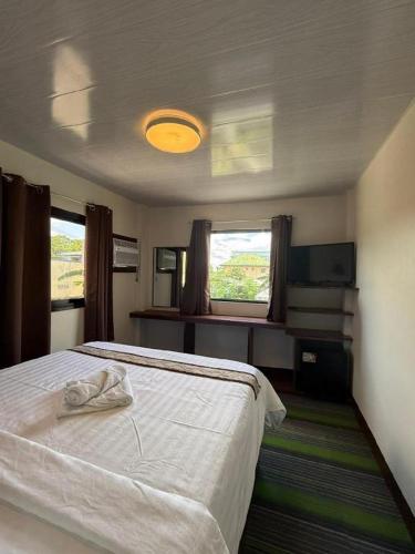 una camera da letto con un letto e un asciugamano sopra di AEROSTOP HOTEL & RESTAURANT a Kutkot