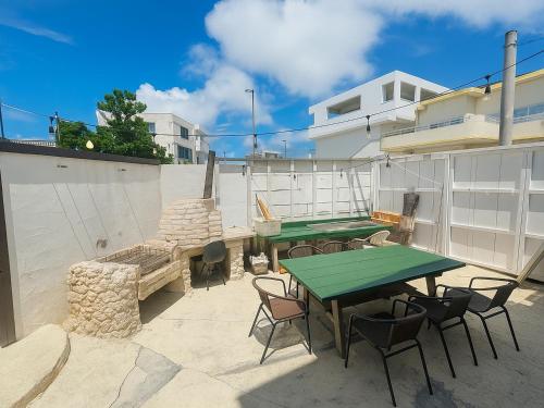 a patio with a ping pong table and chairs at Nagachibi ながちび in Miyako Island