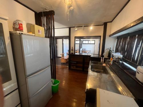 a kitchen with a sink and a counter top at Nagachibi ながちび in Miyako Island