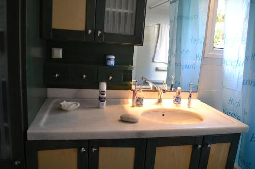a bathroom with a sink and a mirror at Live The Dream in Naxos Chora