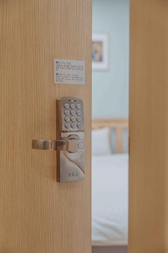 a close up of a door with a remote control at Guest House Brick in Jeju