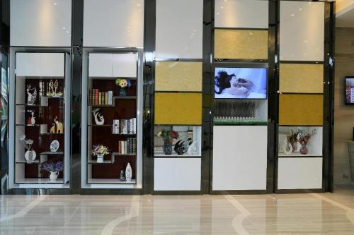 a store with three glass doors with a tv in it at Lavande Hotels Suzhou Railway Station in Suzhou
